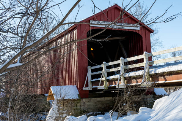 istock historical red covered bridge on a snowy sub zero winters day. 1134127927
