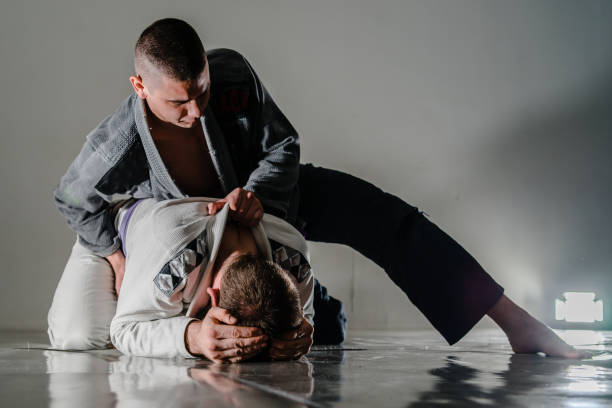 istock Brazilain Jiu JItsu BJJ Fighters in training sparing turtle position dominant 1134128051