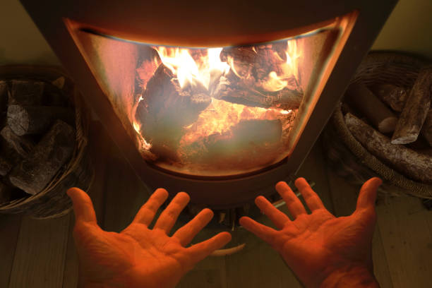 istock Detail of hands warming by fireplace flame 1134130287