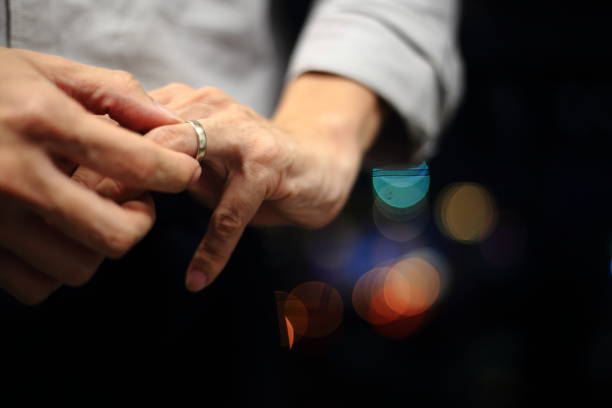 man putting on wedding ring. - wedding behavior horizontal men imagens e fotografias de stock