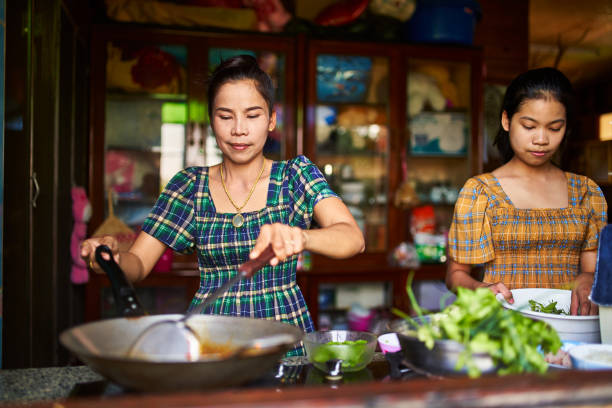 istock thai mother and daughter cooking red curry together 1134134227