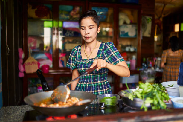 istock thai mother cooking traditional red curry in rustic home kitchen 1134134749