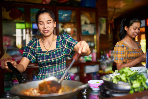 istock thai mother and daughter cooking together in rustic kitchen 1134134750
