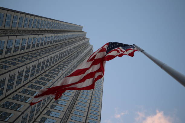 istock American flag fluttering in the wind against a skyscraper 1134139827