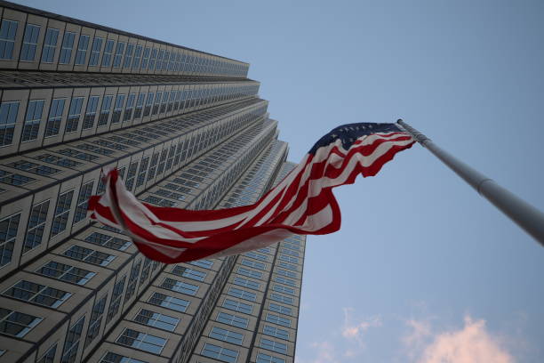 istock American flag fluttering in the wind against a skyscraper 1134139829
