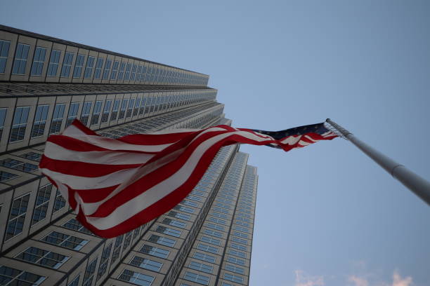istock American flag fluttering in the wind against a skyscraper 1134139832