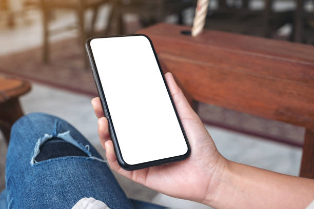 istock hands holding black mobile phone with blank white screen 1134140584