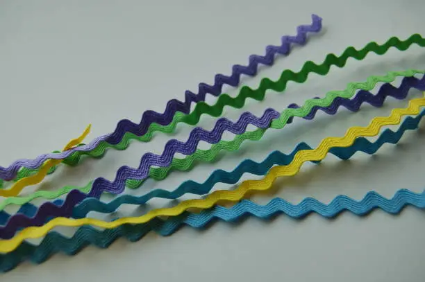 Sewing notions in pastel colored trim in squiggly lines