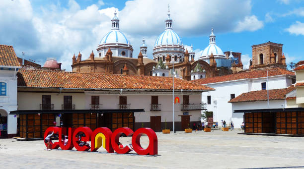 City name sign "Cuenca" Cuenca, Ecuador - March 6 , 2019: San Francisco Plaza (square) in historical center of city Cuenca, UNESCO world heritage site, city name sign "Cuenca" with view of Cathedral at background. Children are playing around the sign cuenca ecuador stock pictures, royalty-free photos & images