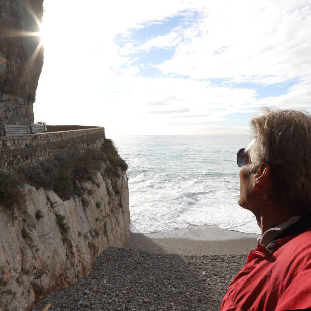 istock Mature man watches sunrise over beach 1134146540
