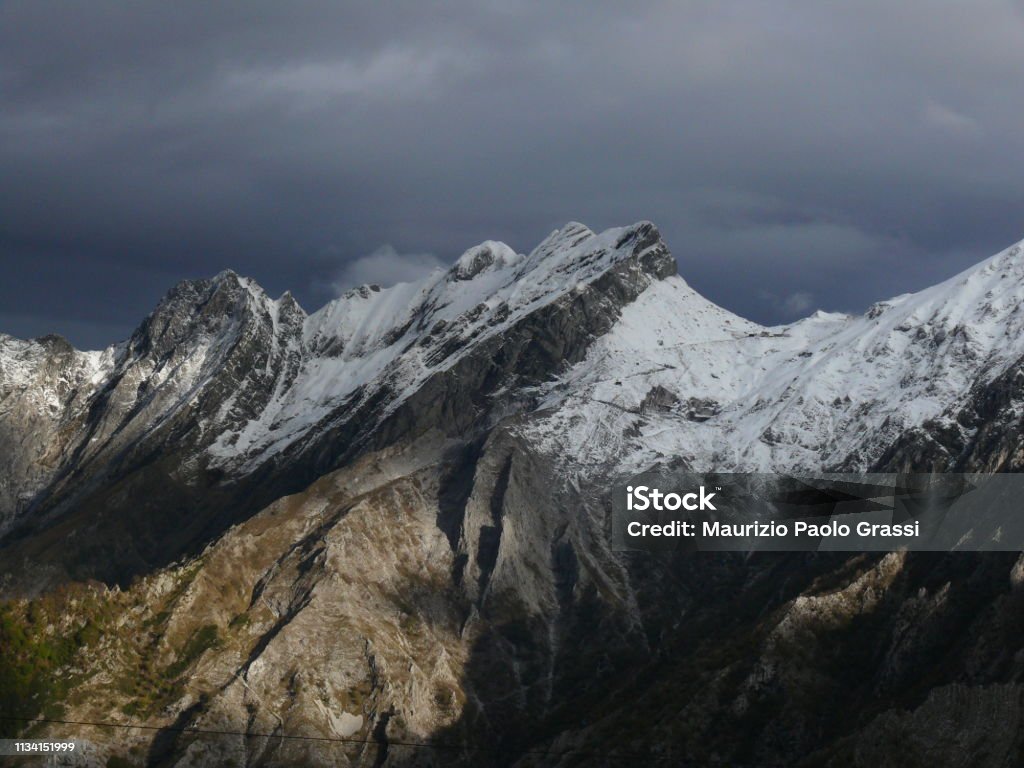 Alpi Apuane in winter with snowy peaks. The white marble quarries are camouflaged with the white of the snow. Passo del Vestito (Lucca) Adventure Stock Photo