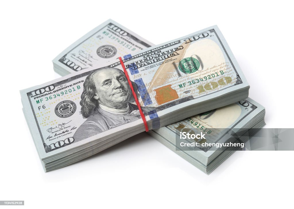 Many bundle of US 100 dollars bank notes isolated on white background Stack Stock Photo