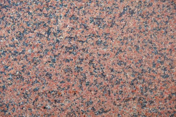 Red mottled granite slab texture Extreme close up shot of mottled granite slab textured backgrounds natural pattern pattern nature rock stock pictures, royalty-free photos & images