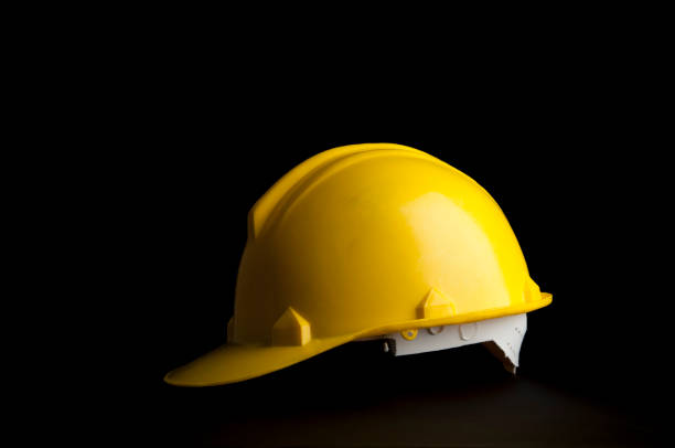 istock Yellow safety Engineer and Architect  helmet on black background. 1134157936