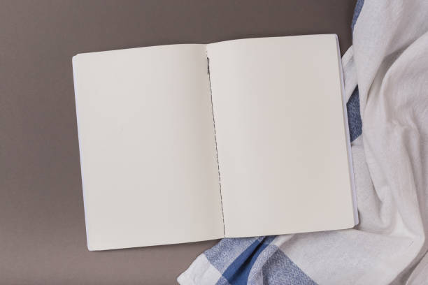 istock Empty sheets of open notebook on a blue background and Towel Clean space 1134159074