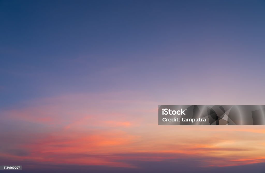 Abstract nature background. Dramatic blue sky with orange colorful sunset clouds in twilight time. Sky Stock Photo