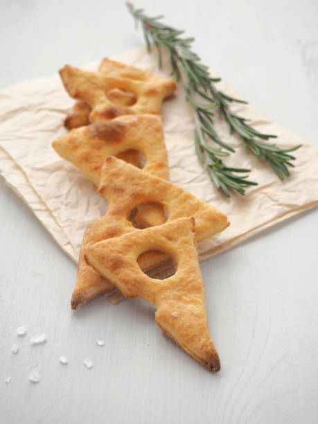 Homemade beer snack. Cheese cookies with fresh rosemary. Vertical. stock photo