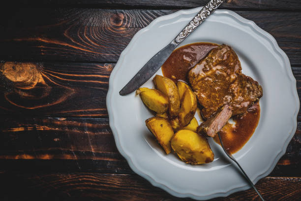 istock Grilled pork steak and fried potatoes 1134165600