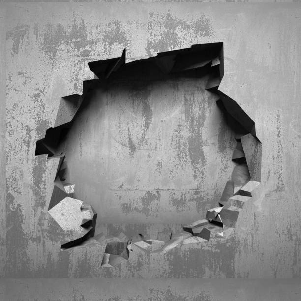 istock Dark cracked broken hole in concrete wall 1134166591