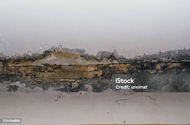 Big Wet Spots And Cracks On The Ceiling Of The Domestic House Room After Heavy Rain And Lot Of Water Stock Photo - Download Image Now