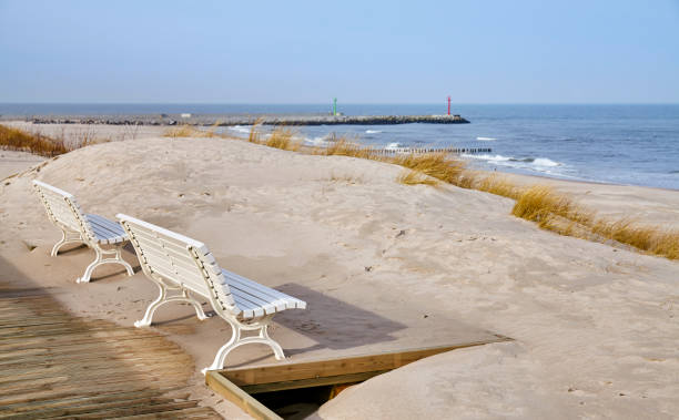 istock Benches along a sea view wooden boardwalk. 1134168663