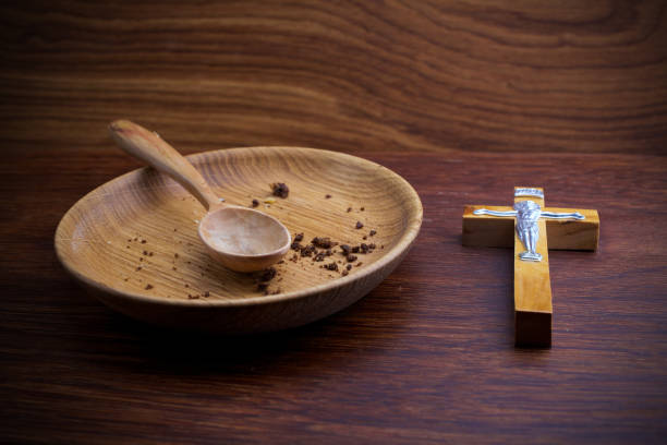 istock Fasting, Lent. Plate and cross on wooden backgroud. 1134171161