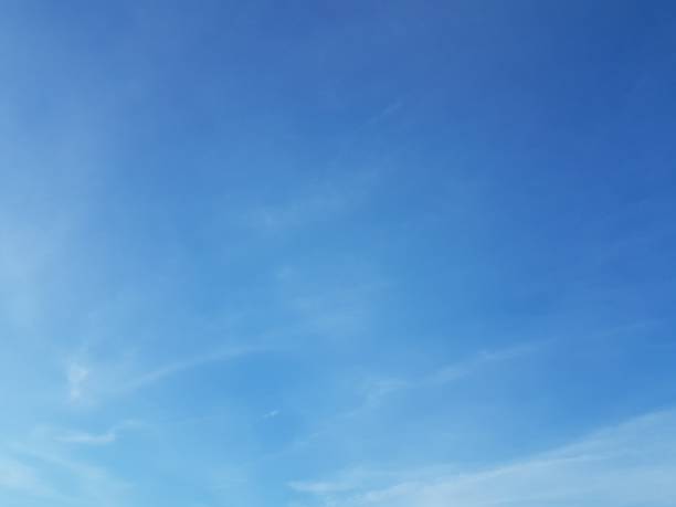 istock Bright blue sky with some white fluffy cloud nature background 1134173685