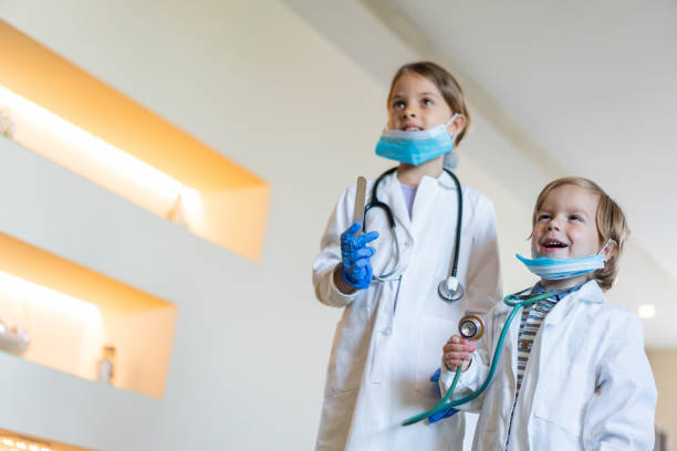 istock Below view of two little doctors having fun at home. 1134173861