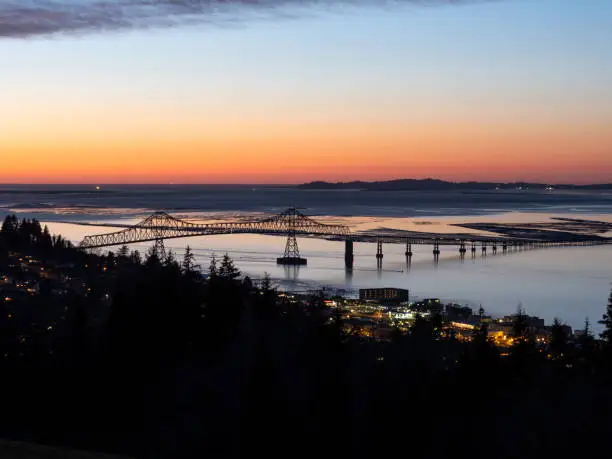An evening look at the bridge spanning the Columbia River from Oregon to Washington State. This is the Astoria–Megler Bridge. Crosses from Astoria Oregon to near Megler, Washington. Is unusually long at a little over 4 miles.
