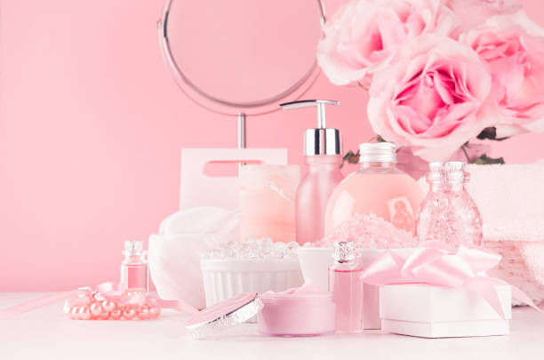 istock Elegant decor for romantic girlish dressing table - different bath, spa cosmetics, accessories, roses bouquet, round mirror in pastel pink color on white wood board. 1134177733