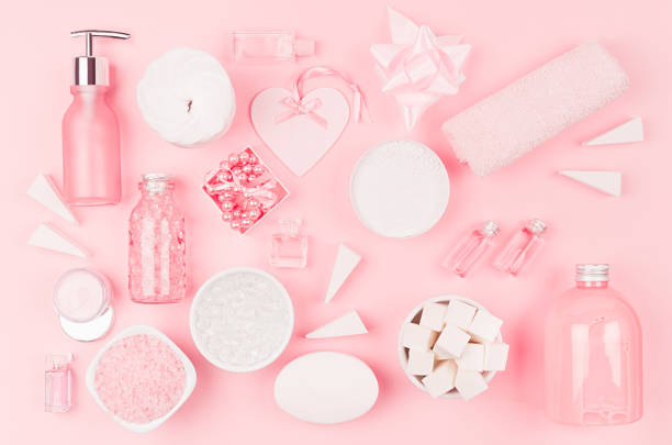 istock Different cosmetic products and accessories in pink and silver color as decorative pattern on soft light pink background, top view. 1134180074