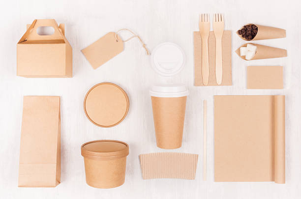 istock Food branding identity mockup in light modern style - blank coffee cup, packet, box, notebook, label, card of brown paper  on white wood board. 1134180774