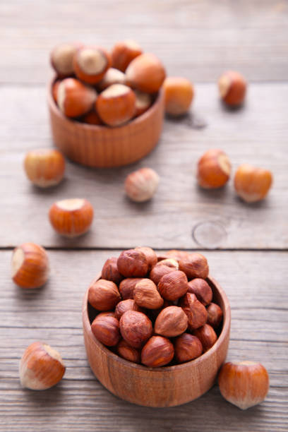 istock Delicious hazelnut in the wooden bowl on white background 1134180865