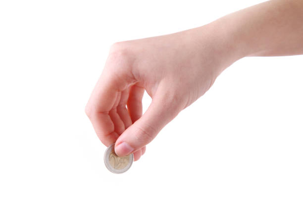 istock A female hand hold a coin isolated white at the studio. 1134181037