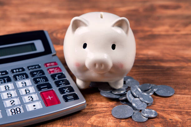 istock piggy bank, calculator and coins 1134181972