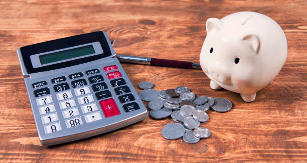 istock piggy bank, calculator and coins 1134181983
