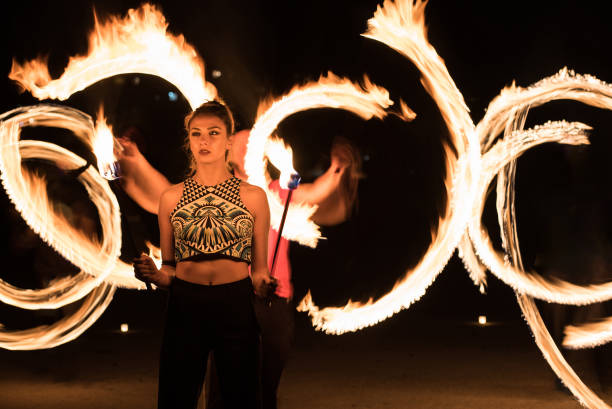 istock Girl with fire torch and light painting 1134183554