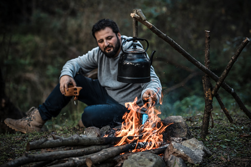 Handsome Adult Male Making Barbecue In Forest Camp