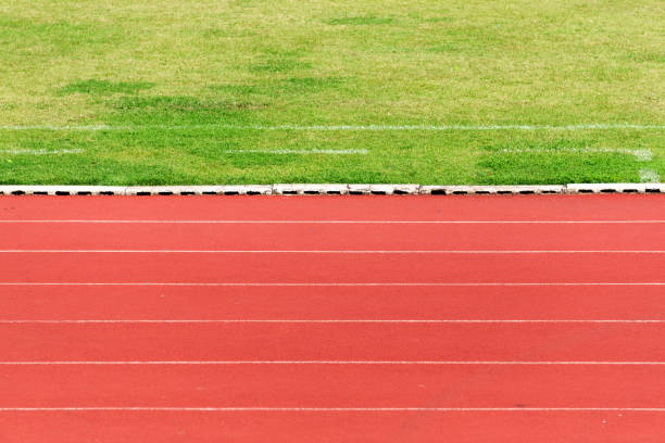 istock Natural green grass field and orange Running Track background. 1134187946