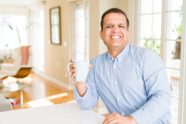 istock Middle age man enjoying and drinking a cup of coffee at home 1134188023