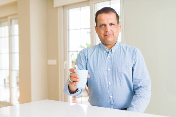 istock Middle age man drinking coffee in the morning at home with a confident expression on smart face thinking serious 1134188094