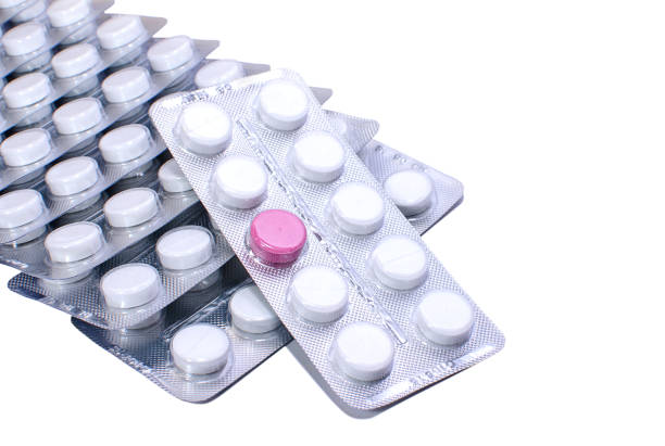 istock One red pill and many white ones in blister packs 1134188167