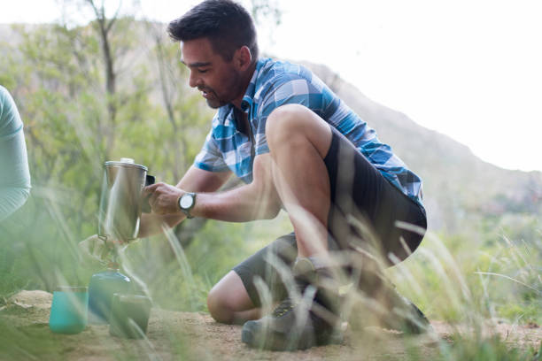 istock Mid adult man making coffee in the morning while camping 1134188364