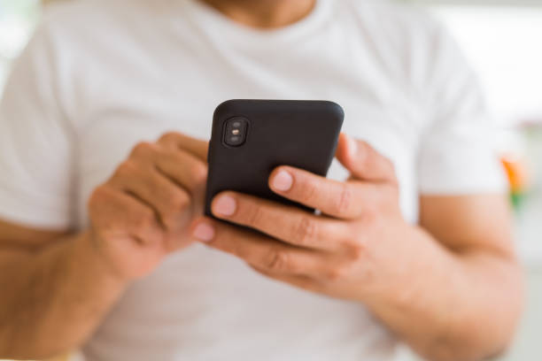 istock Close up of middle age man hands using smartphone at home 1134188396