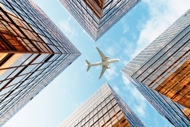 istock Airplane flying over business skyscrapers 1134189654