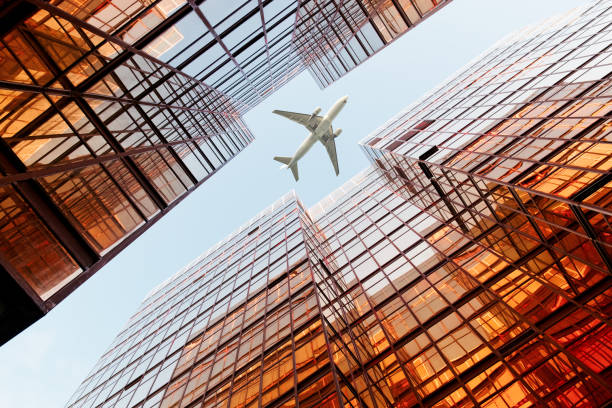 istock Airplane flying over business skyscrapers 1134189656