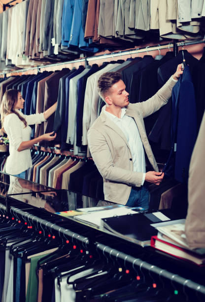 istock Young couple examining various suits 1134191116