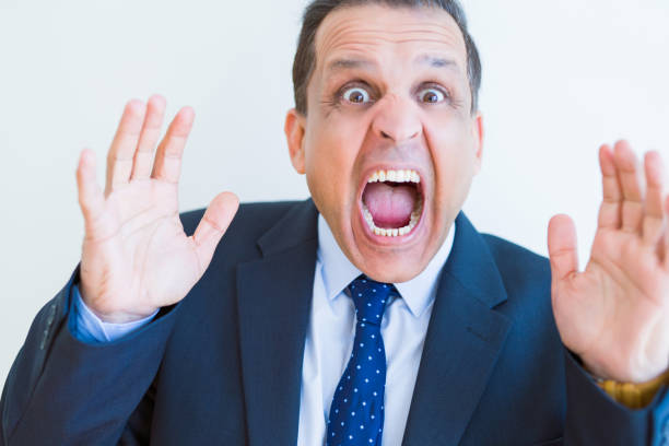 istock Middle age man shouting crazy with hands over mouth over white wall background 1134191157
