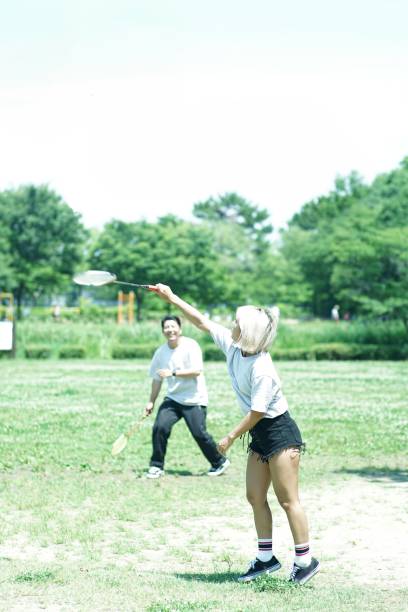 istock Young Couple is Playing Badminton in the Park 1134191166