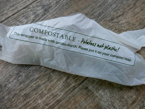 Potato starch compostable wrapper A biodegradable potato starch compostable wrapper lying on a wooden floor, made as an alternative to plastic packaging, which will help save the environment and it needing to go to landfill as a more environmentally friendly product. biodegradable photos stock pictures, royalty-free photos & images